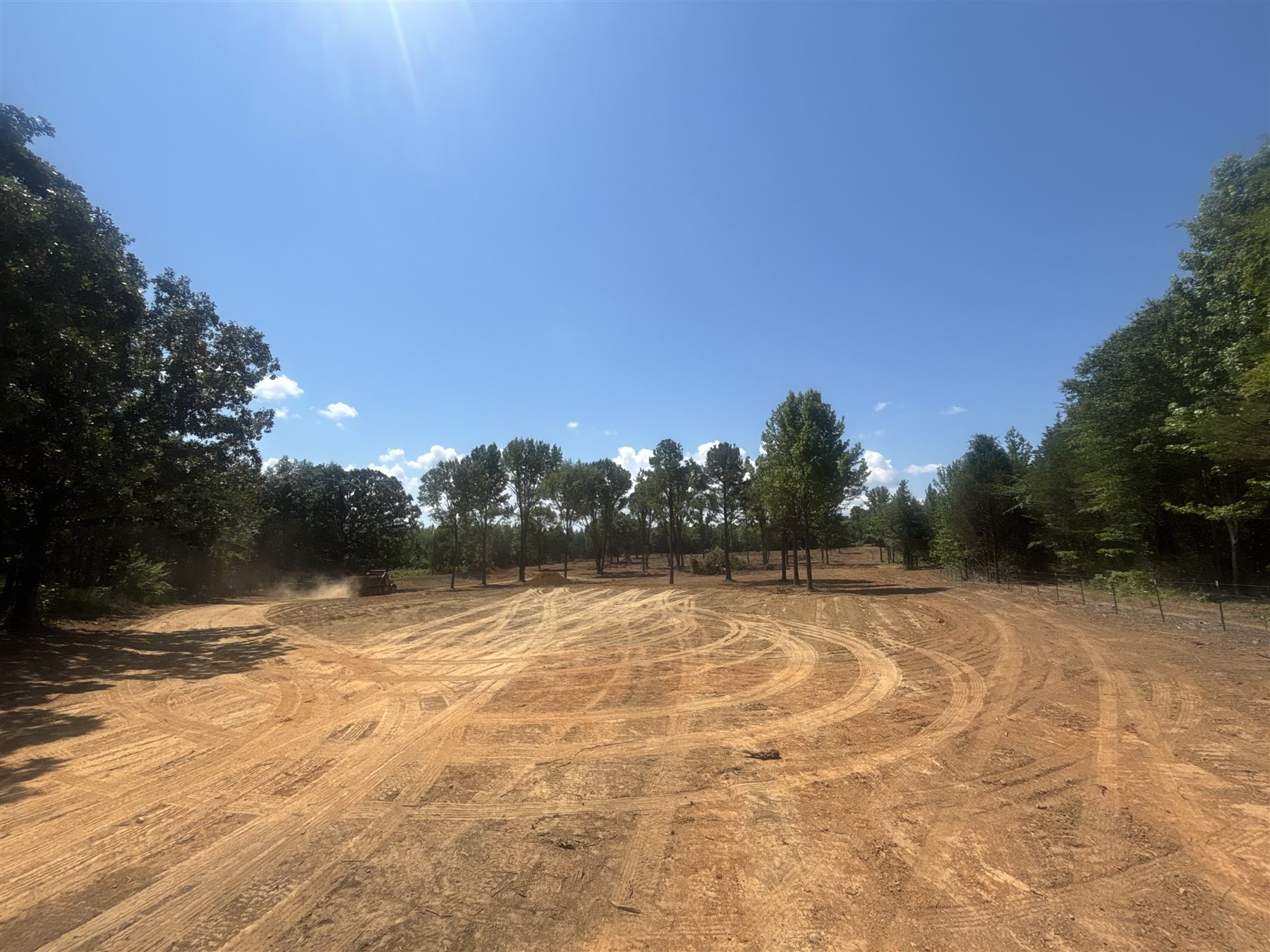 Large graded pad surrounded by trees